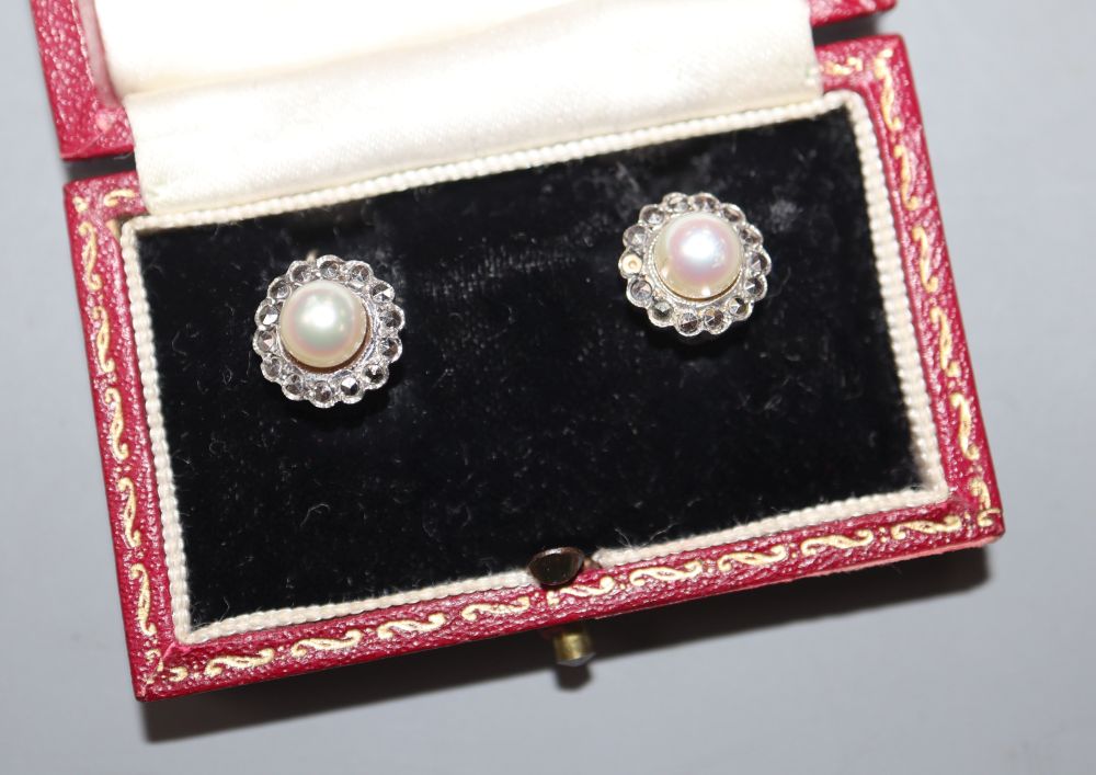 A pair of white metal (stamped silver) and cultured pearl set earclips, in a bright cut setting, 11mm, in Harrods box.